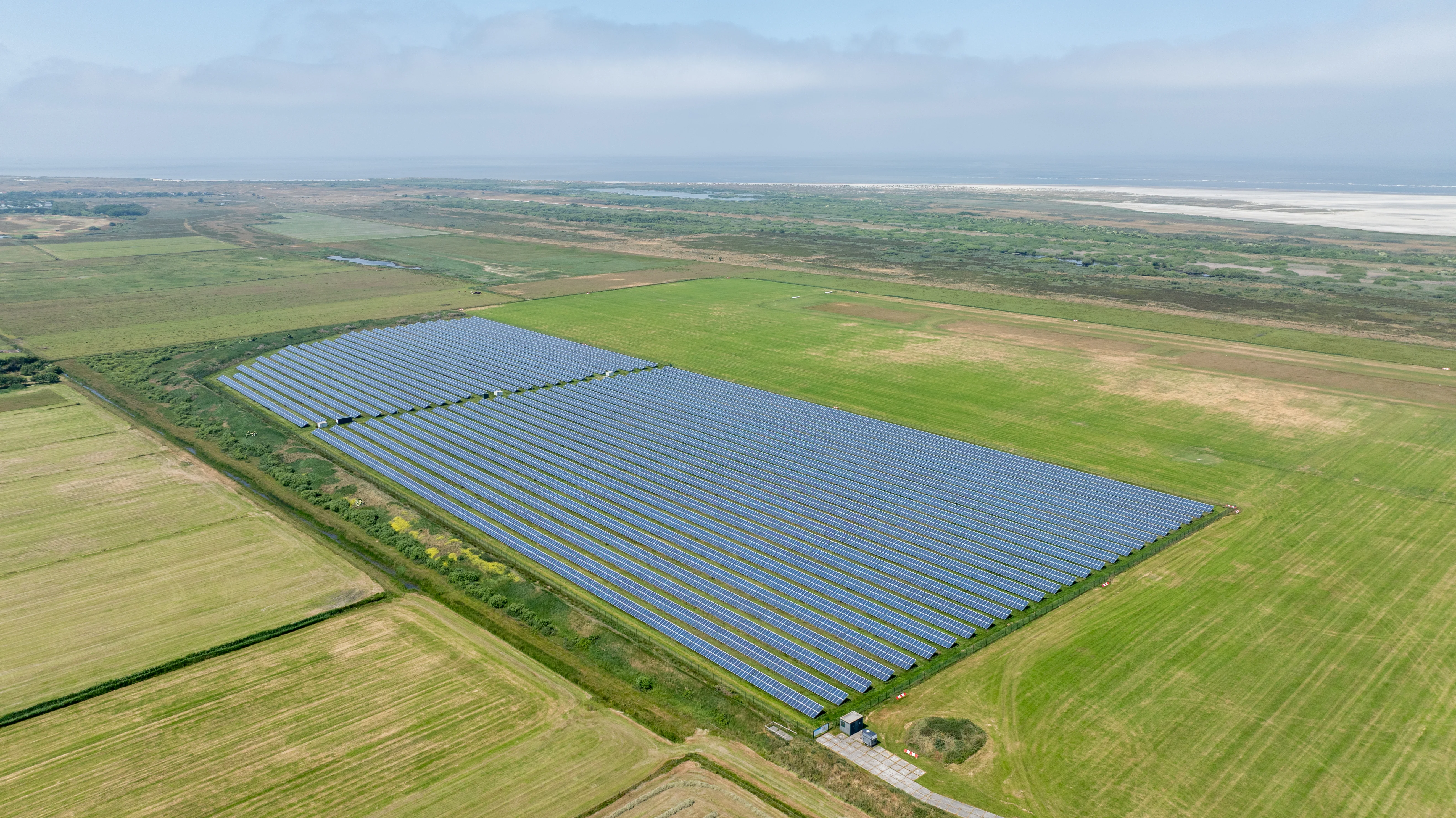 wind turbine maintenance aerial view, crane lifting turbine blade, wind farm construction, professional drone photography, renewable energy infrastructure