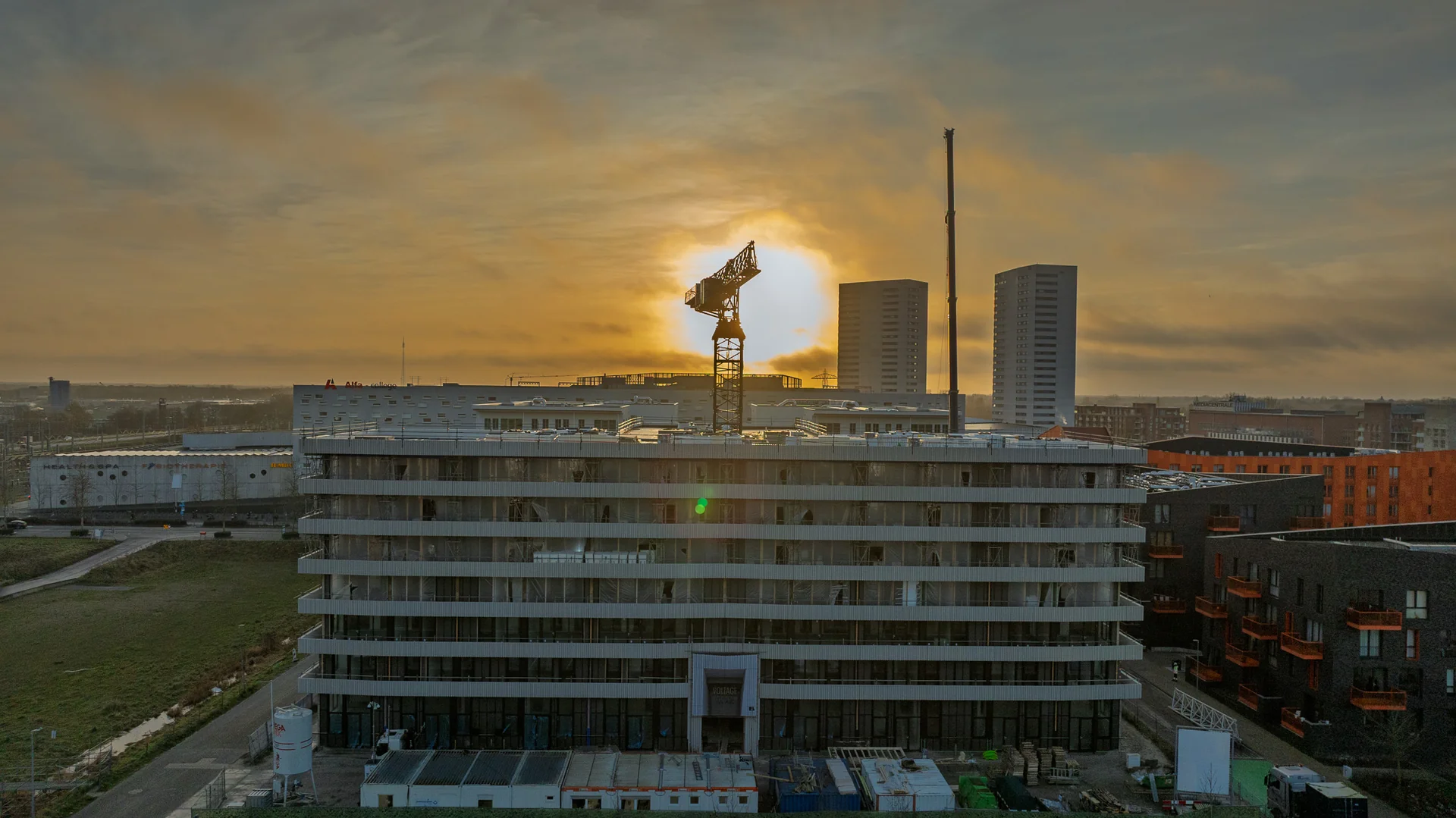 large construction site aerial view with cranes and buildings under construction, infrastructure development, professional drone photography, urban development landscape